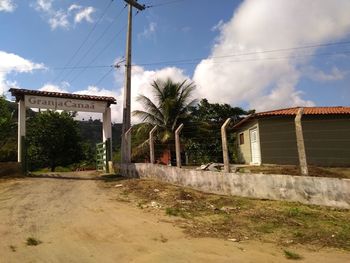 Road by building against sky