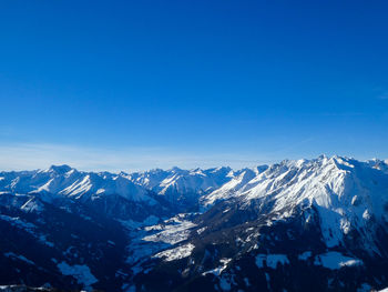 Scenic view of snowcapped mountains against clear blue sky