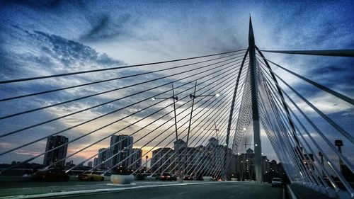 View of suspension bridge against cloudy sky