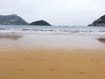 View of calm beach against sky