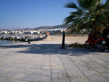 People at beach against clear sky