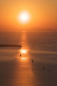 Scenic view of sea against orange sky