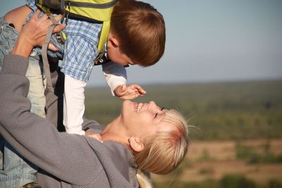 Rear view of father and son on baby