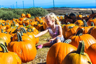 Full length of girl on pumpkin field