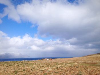 Scenic view of landscape against cloudy sky