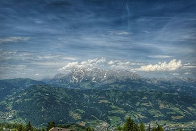 Scenic view of mountains against cloudy sky