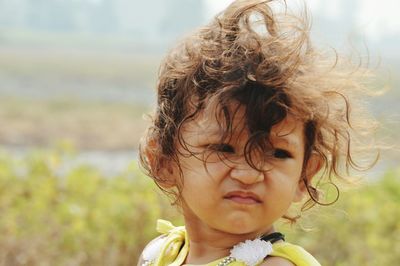 Close-up of girl with tousled hair looking away