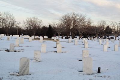 View of cemetery against sky during winter