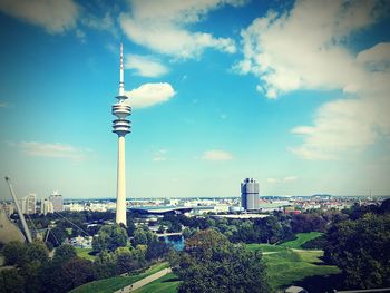 View of communications tower and buildings against sky