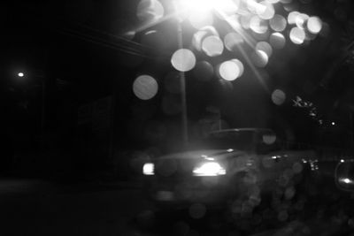 Defocused image of illuminated street at night