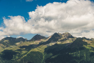 Snow capped peaks of cloud shrouded rocky mountains