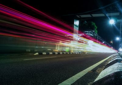 Light trails on road in city at night