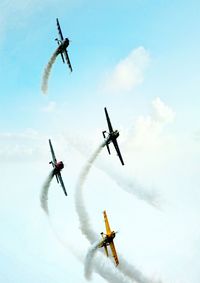 Low angle view of airshow against sky