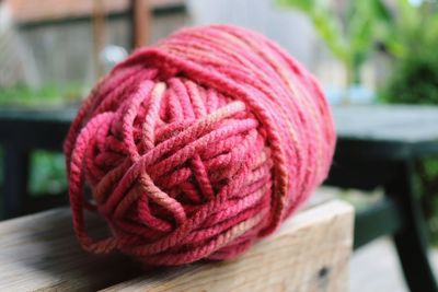 Close-up of pink thread ball on table