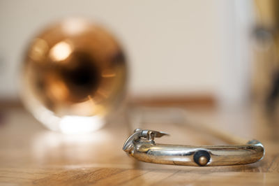 Close-up of trombone on parquet floor