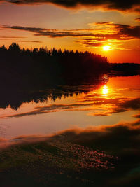 Scenic view of lake against romantic sky at sunset