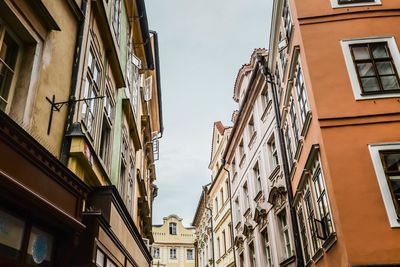 Low angle view of buildings in town against sky