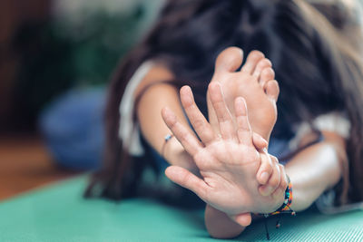 Young woman doing yoga on exercise mat