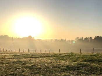 Scenic view of field against sky during sunset