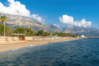 Scenic view of sea and mountains against sky