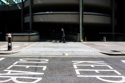 Man walking on road in city