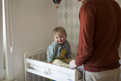 High angle view of boy playing with teddy bear