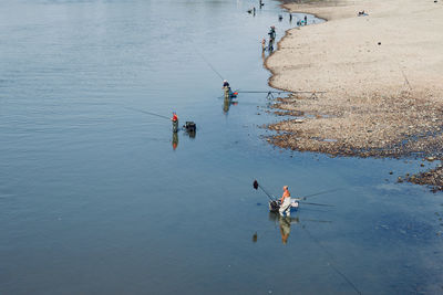 High angle view of people fishing in sea