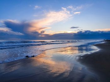 Scenic view of beach against sky during sunset