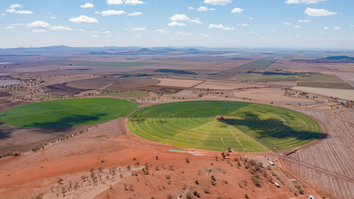 Aerial view of farms against sky