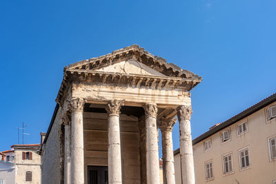 Low angle view of historical building against clear blue sky