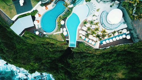 High angle view of swimming pool by building against sky