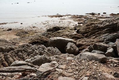 Rocks on beach against sky