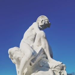 Low angle view of statue against clear blue sky