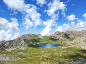 Scenic view of lake by mountains against sky