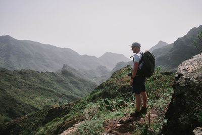 Rear view of man walking on mountain