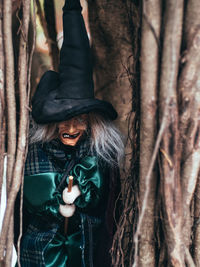 Evil witch on nature background, close up portrait of old lady, halloween background