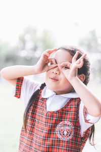 Close-up portrait of schoolgirl gesturing