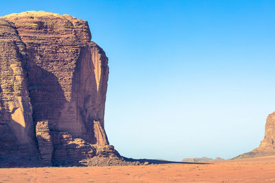 Rock formations in desert against clear blue sky