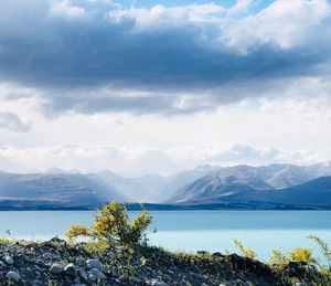 Scenic view of lake and mountains against sky