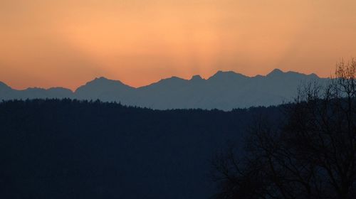 Scenic view of silhouette mountains against sky at sunset