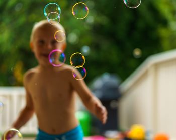 High angle view of shirtless man in bubbles