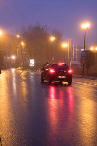 Cars on illuminated road at night