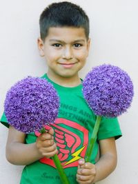 Portrait of happy boy holding purple