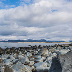 Rocks on beach against sky