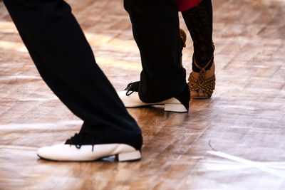 Low section of couple dancing on floor