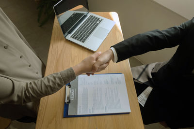 High angle view of man using laptop on table