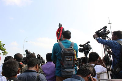 Rear view of people looking at sky