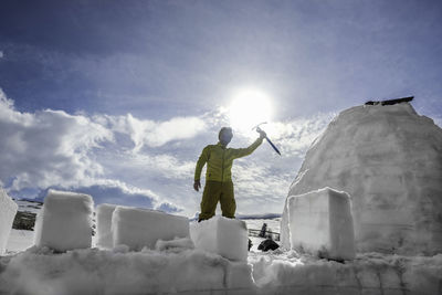 Low angle view of man working on snow