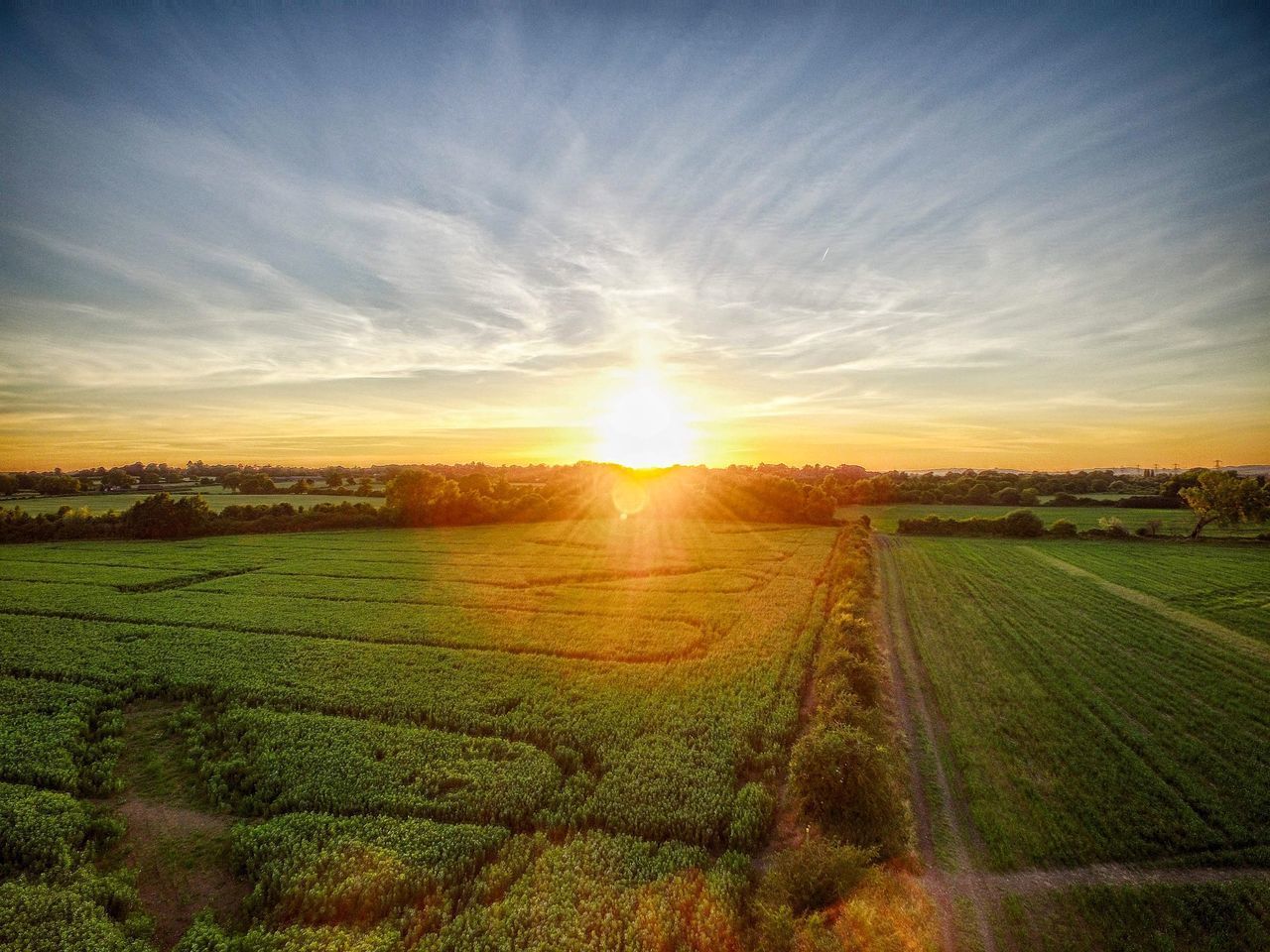 SCENIC VIEW OF AGRICULTURAL FIELD AGAINST SKY AT SUNSET