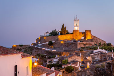 Illuminated buildings against clear sky